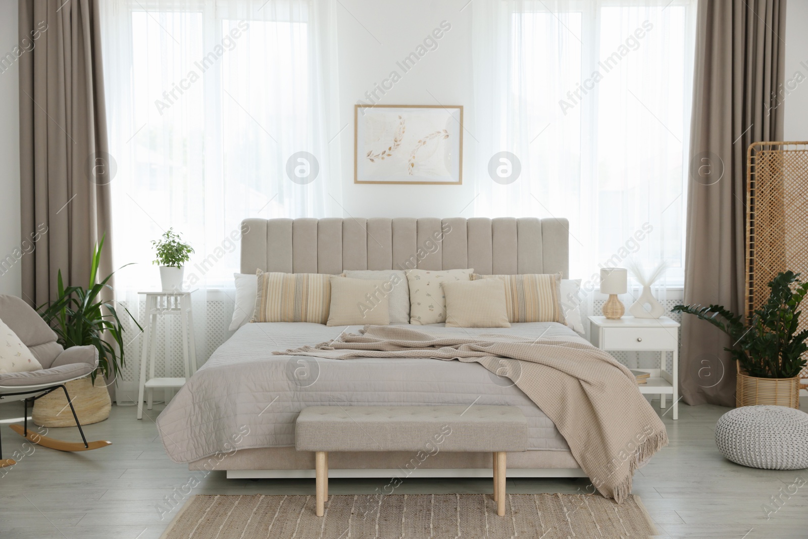 Photo of Big comfortable bed in room. Interior design