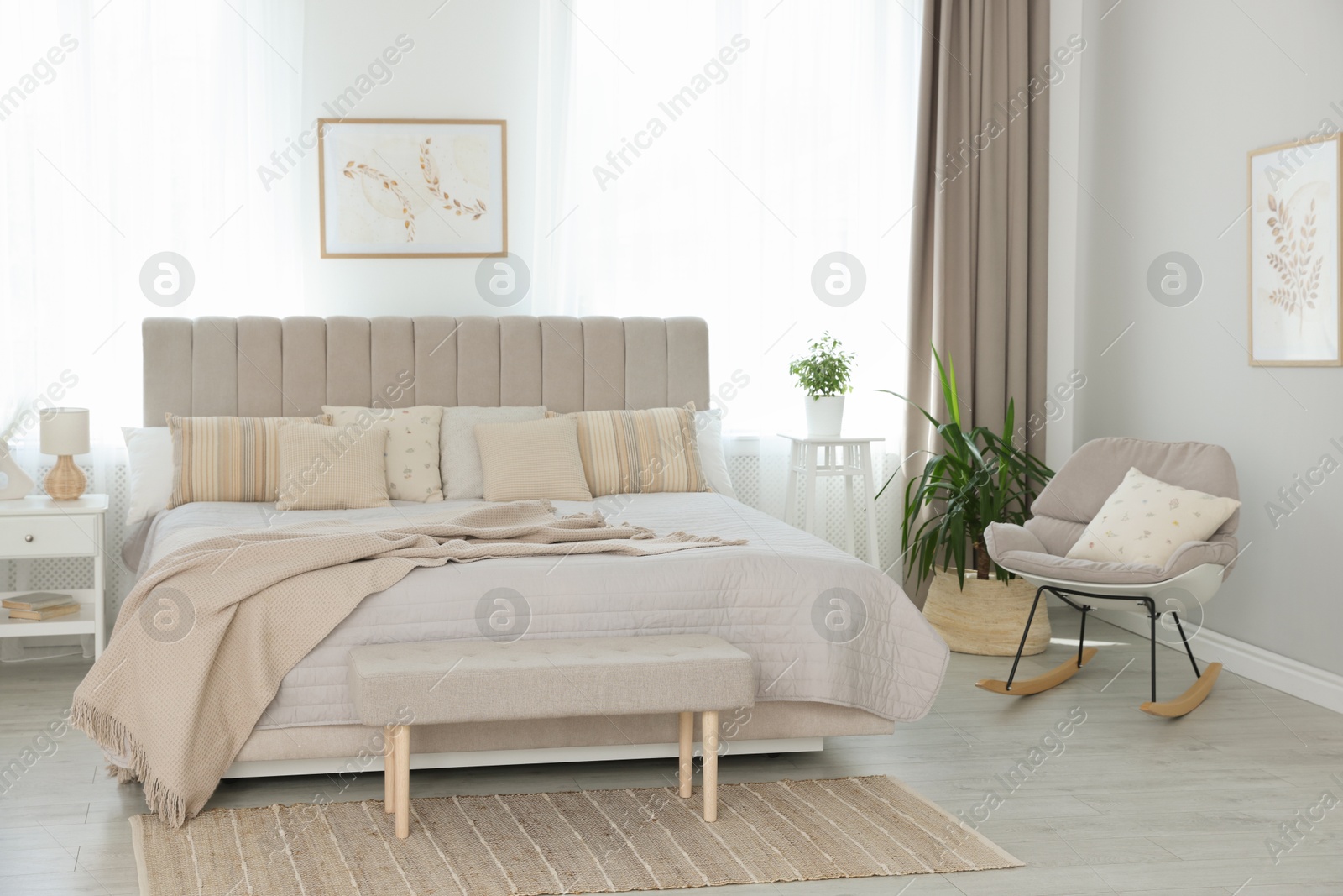 Photo of Big comfortable bed in room. Interior design