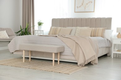 Photo of Big comfortable bed in room. Interior design