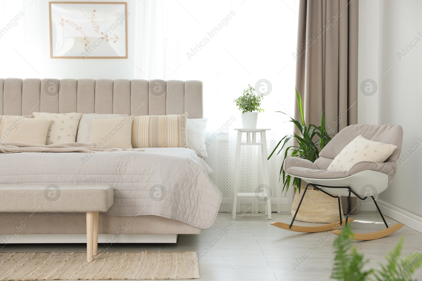 Photo of Big comfortable bed in room. Interior design