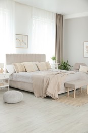 Photo of Big comfortable bed in room. Interior design