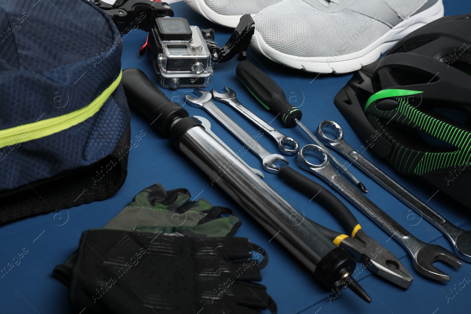 Photo of Bicycle accessories and tools on blue wooden background