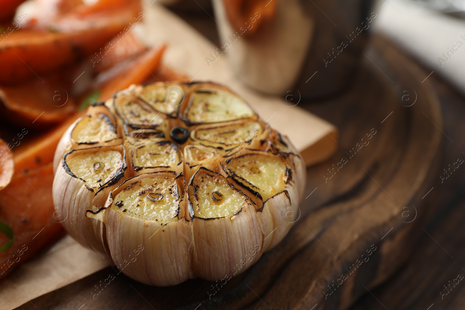 Photo of Head of baked garlic on table, closeup