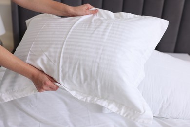 Woman changing clean bed linens at home, closeup