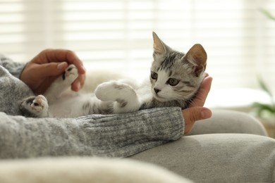 Photo of Woman with cute kitten at home, closeup