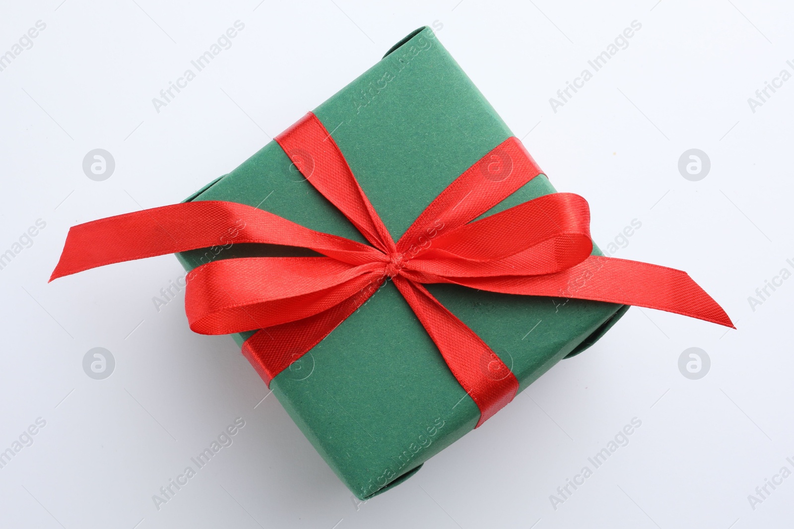 Photo of Beautiful gift box with red bow isolated on white, top view