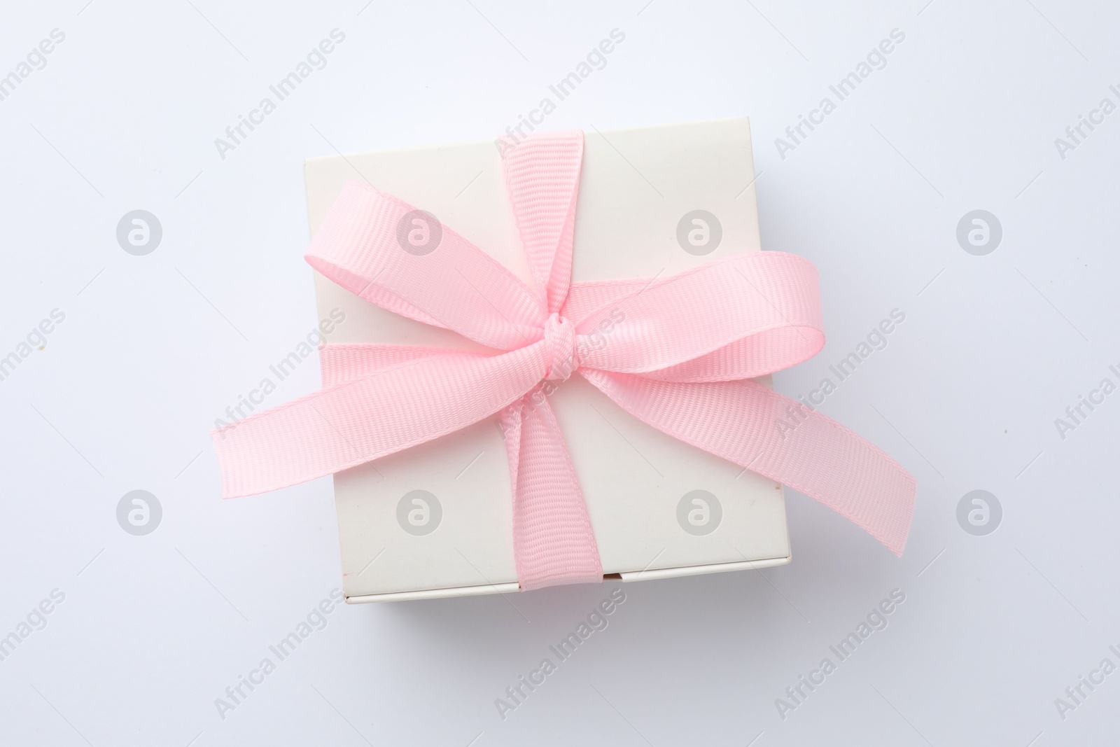 Photo of Beautiful gift box with pink bow isolated on white, top view