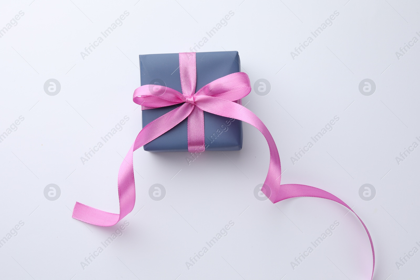 Photo of Beautiful gift box with pink bow isolated on white, top view