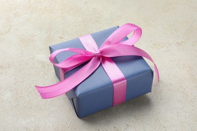 Photo of Beautiful gift box with pink bow on light grey table