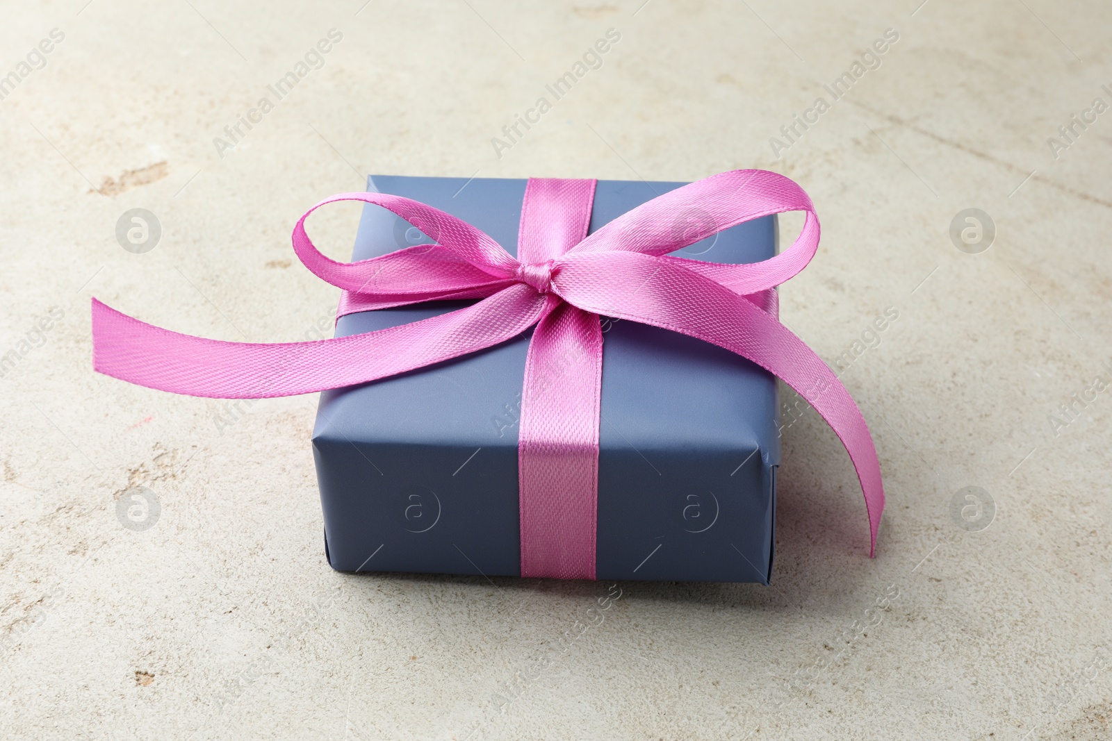 Photo of Beautiful gift box with pink bow on light grey table