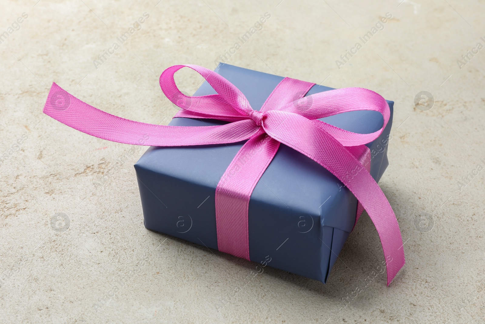 Photo of Beautiful gift box with pink bow on light grey table