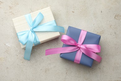 Photo of Two beautiful gift boxes on light grey table, flat lay