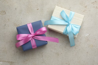 Photo of Two beautiful gift boxes on light grey table, flat lay