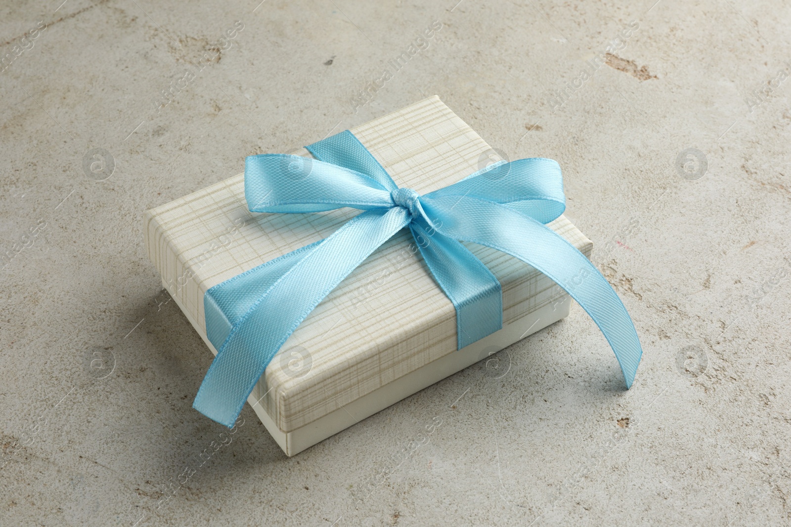 Photo of Beautiful gift box with bow on light grey table