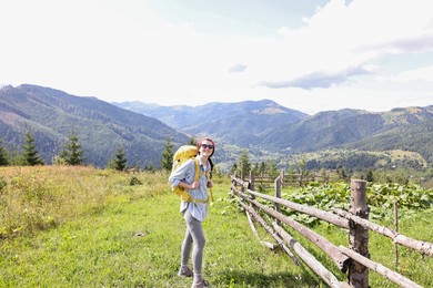 Photo of Happy young hiker with backpack in mountains