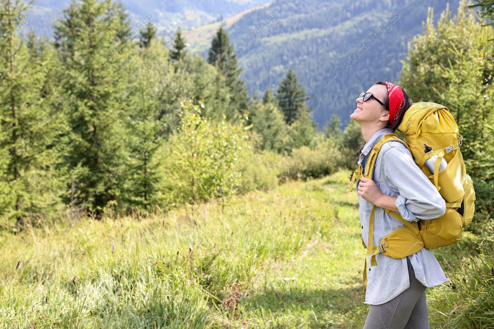 Photo of Young hiker with backpack enjoying time in forest