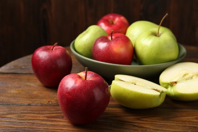 Photo of Fresh red and green apples on wooden table