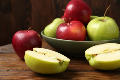 Photo of Fresh red and green apples on wooden table