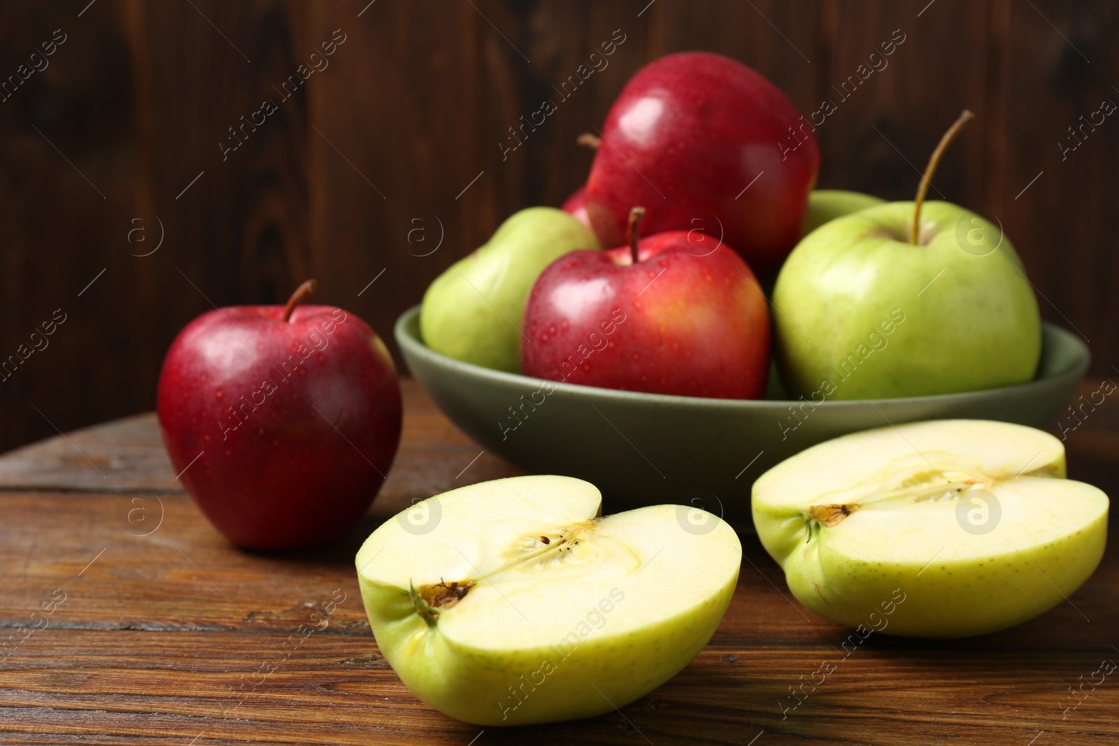 Photo of Fresh red and green apples on wooden table