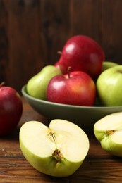 Photo of Fresh red and green apples on wooden table