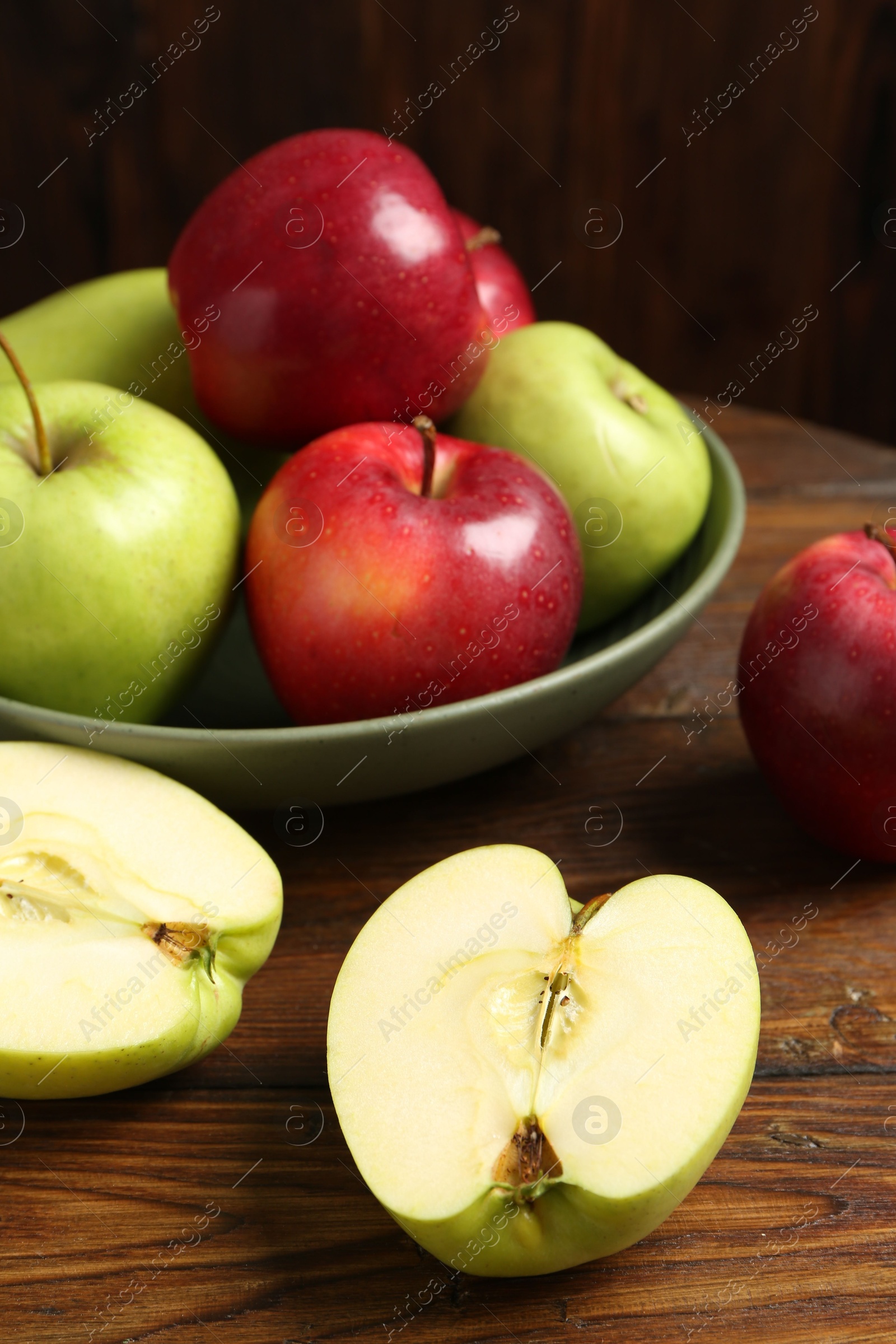 Photo of Fresh red and green apples on wooden table, closeup