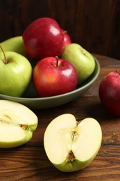 Photo of Fresh red and green apples on wooden table, closeup