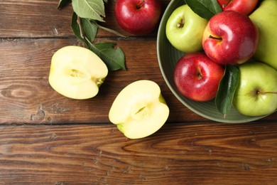 Photo of Fresh red and green apples on wooden table, flat lay