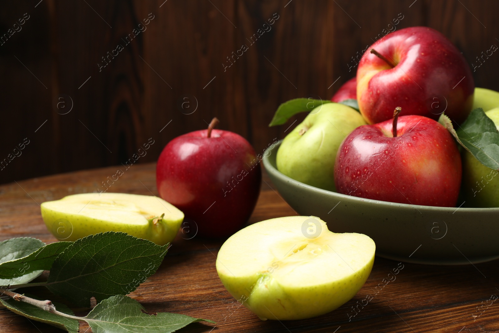 Photo of Fresh red and green apples on wooden table