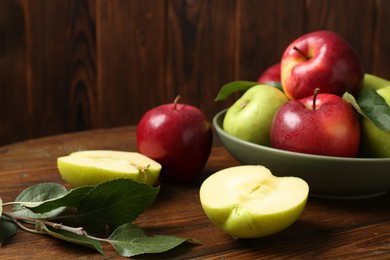 Fresh red and green apples on wooden table