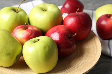 Photo of Fresh red and green apples on grey table, closeup