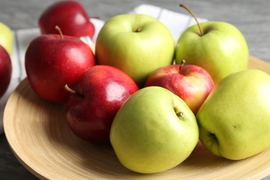 Photo of Fresh red and green apples on grey table, closeup