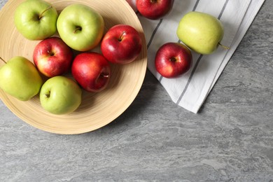 Photo of Fresh red and green apples on grey table, flat lay. Space for text