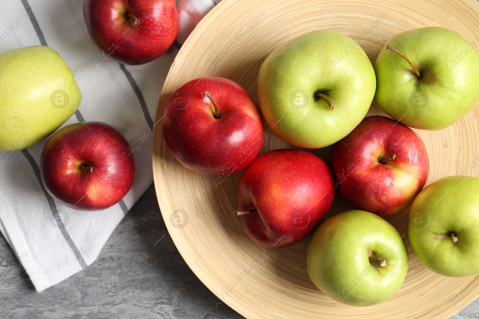 Fresh red and green apples on grey table, flat lay Photo of Fresh red and green apples on grey table, flat lay