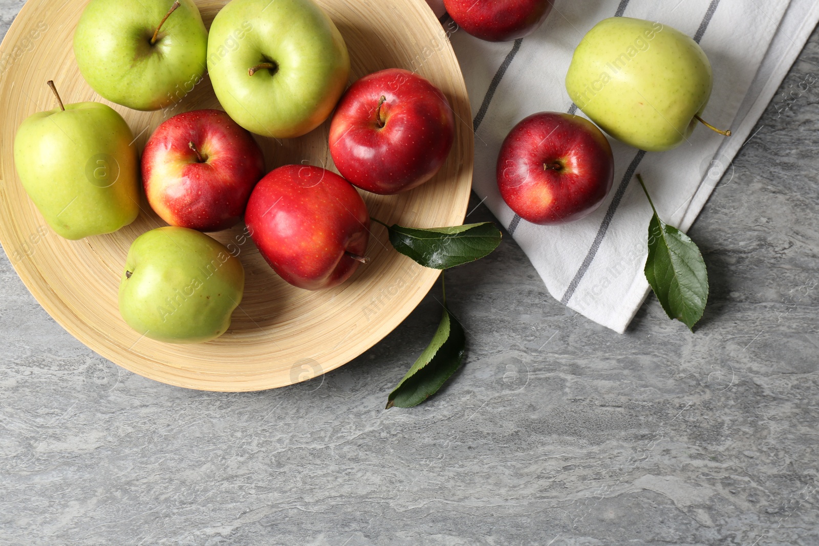 Photo of Fresh red and green apples on grey table, flat lay