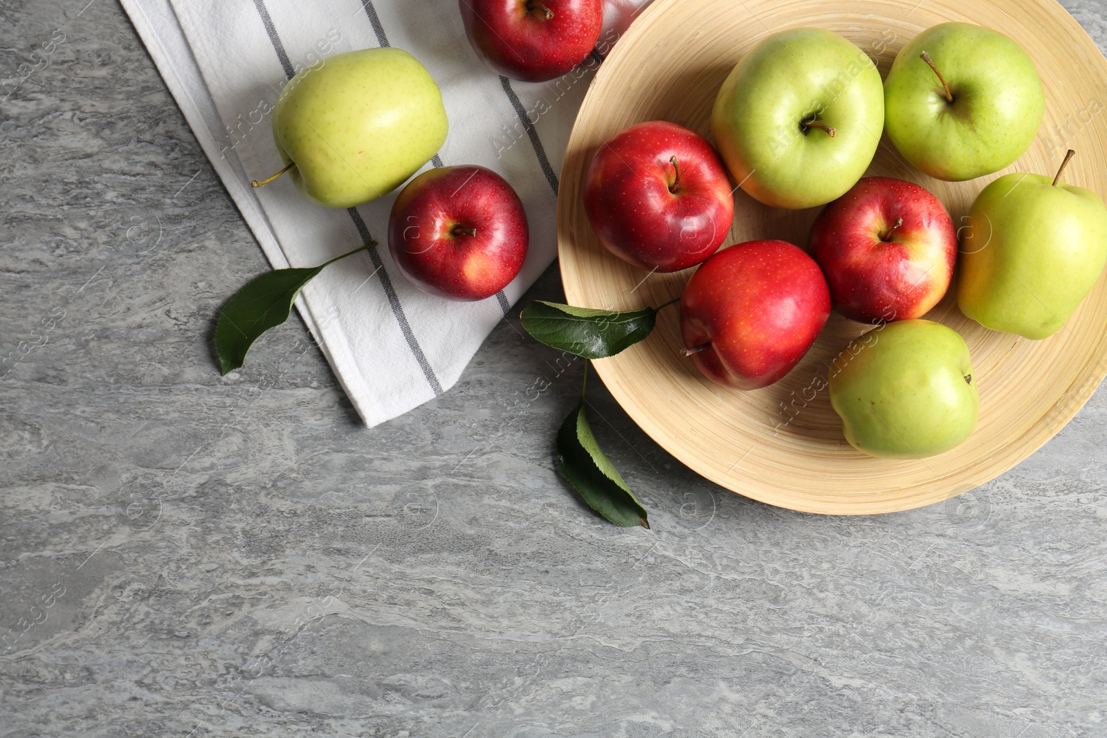 Fresh red and green apples on grey table, flat lay. Space for text Photo of Fresh red and green apples on grey table, flat lay. Space for text