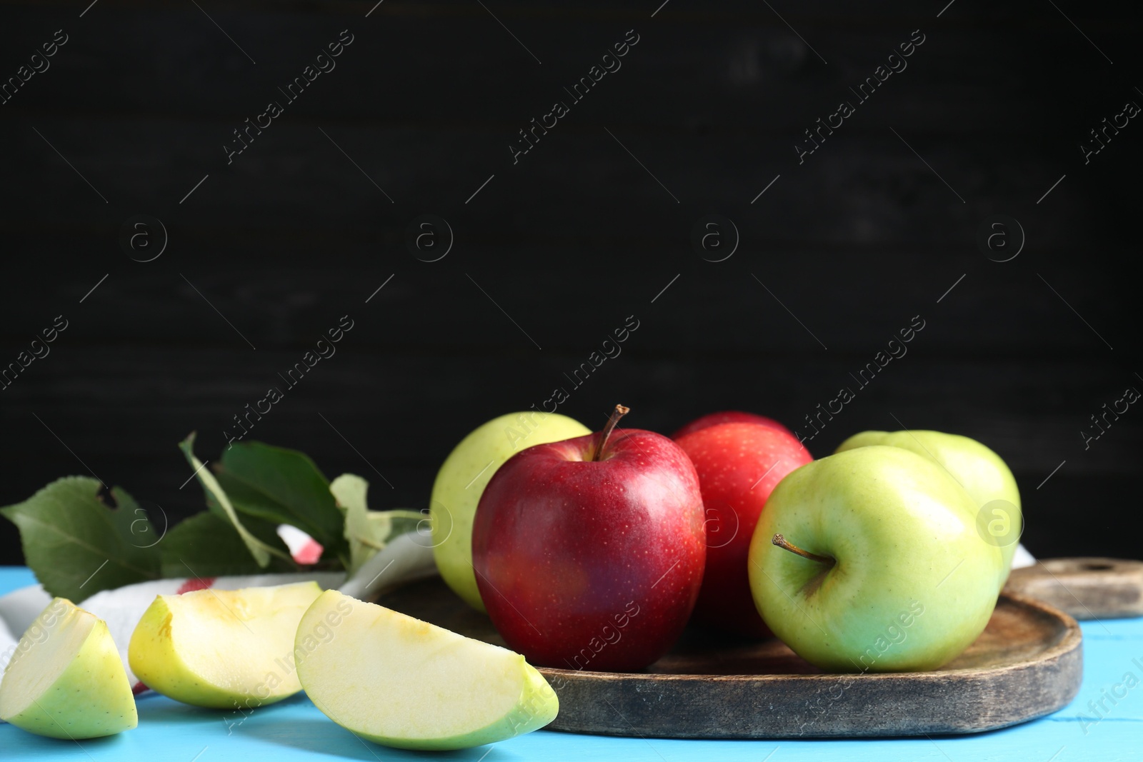 Fresh red and green apples on light blue wooden table Photo of Fresh red and green apples on light blue wooden table