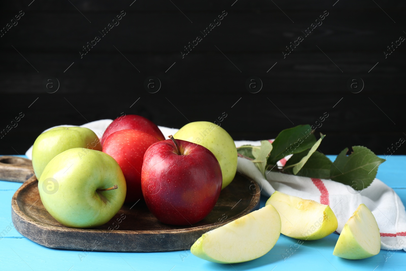 Fresh red and green apples on light blue wooden table Photo of Fresh red and green apples on light blue wooden table