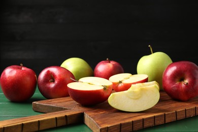 Photo of Fresh ripe apples on green wooden table