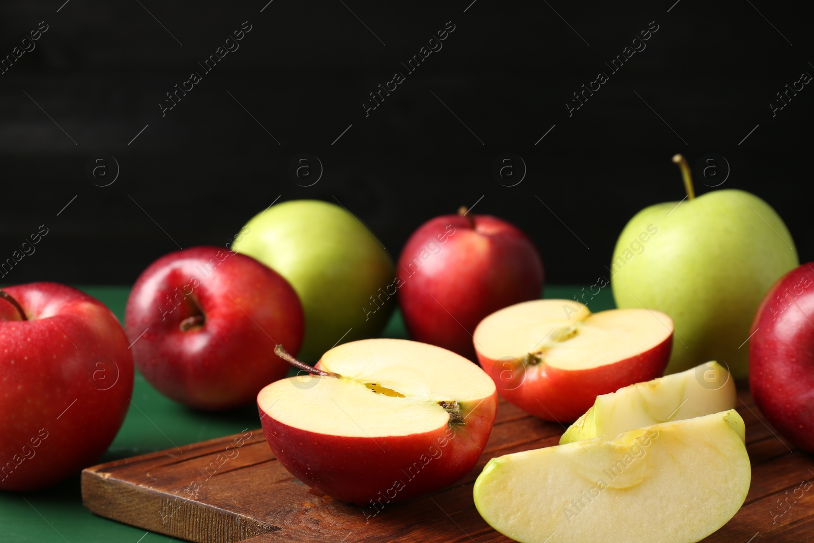 Fresh ripe apples on green wooden table Photo of Fresh ripe apples on green wooden table