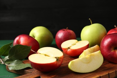 Photo of Fresh ripe apples on green wooden table