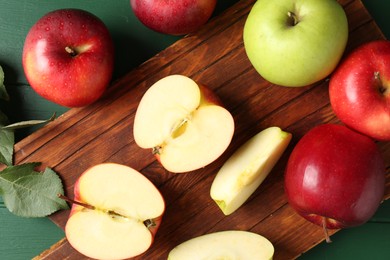 Photo of Fresh ripe apples on green wooden table, flat lay