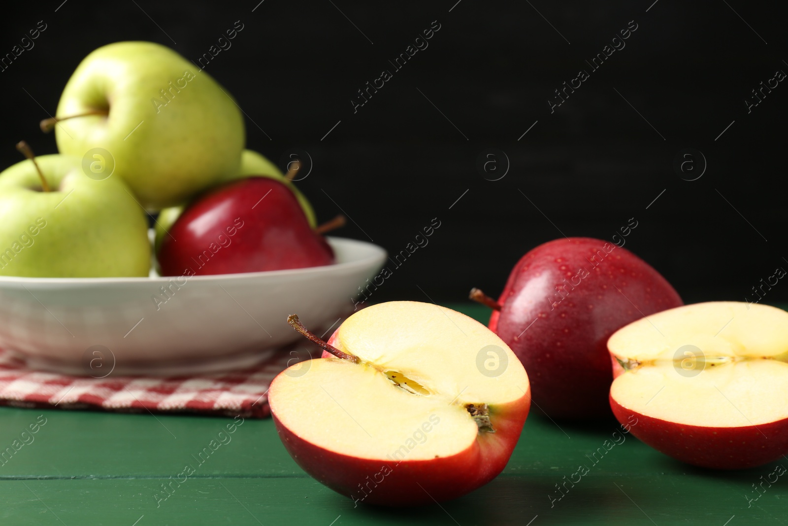 Photo of Fresh ripe apples on green wooden table