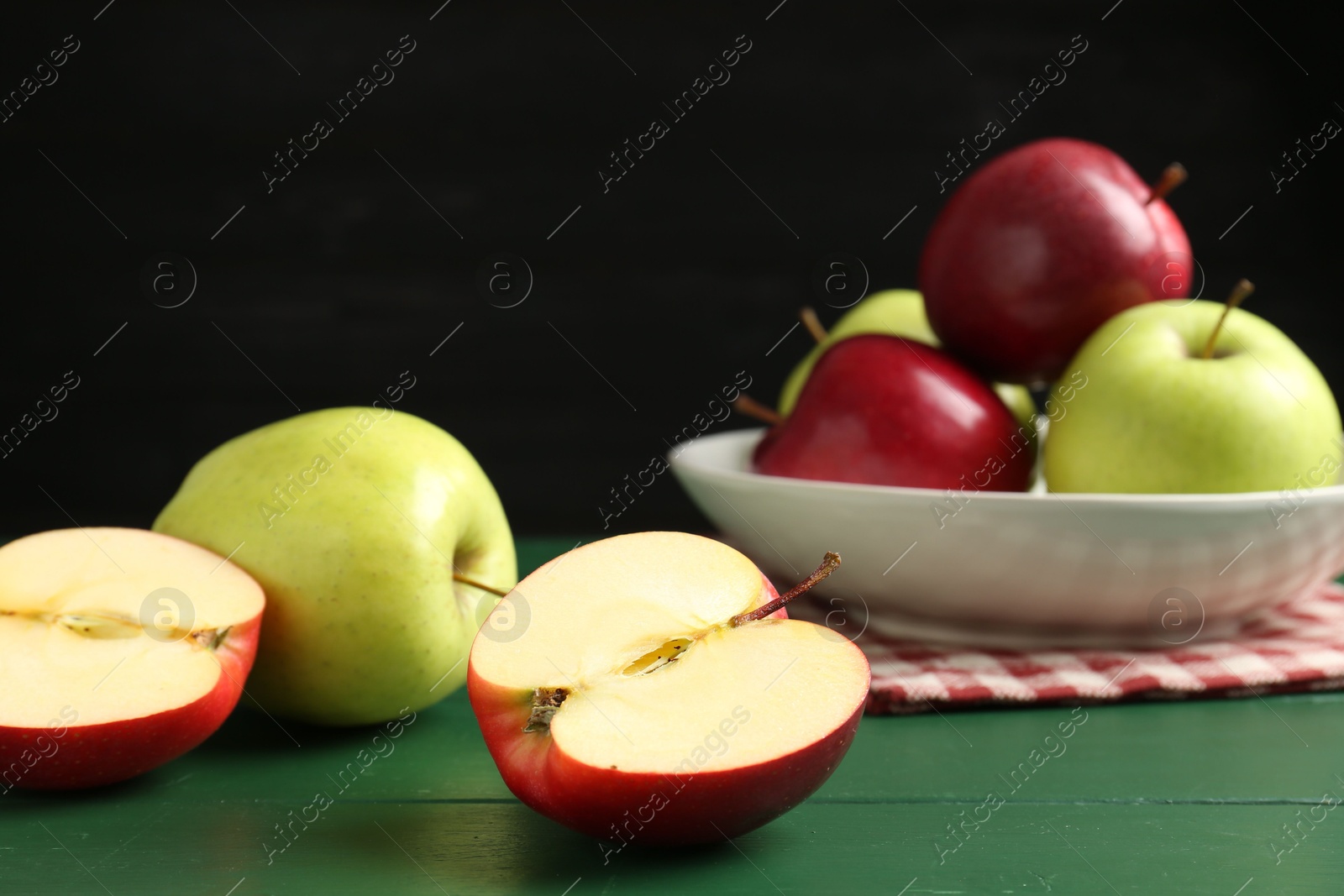 Photo of Fresh ripe apples on green wooden table