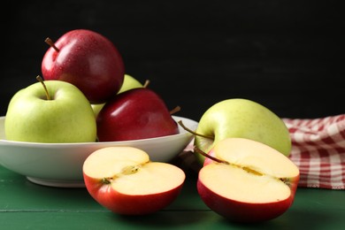 Photo of Fresh ripe apples on green wooden table