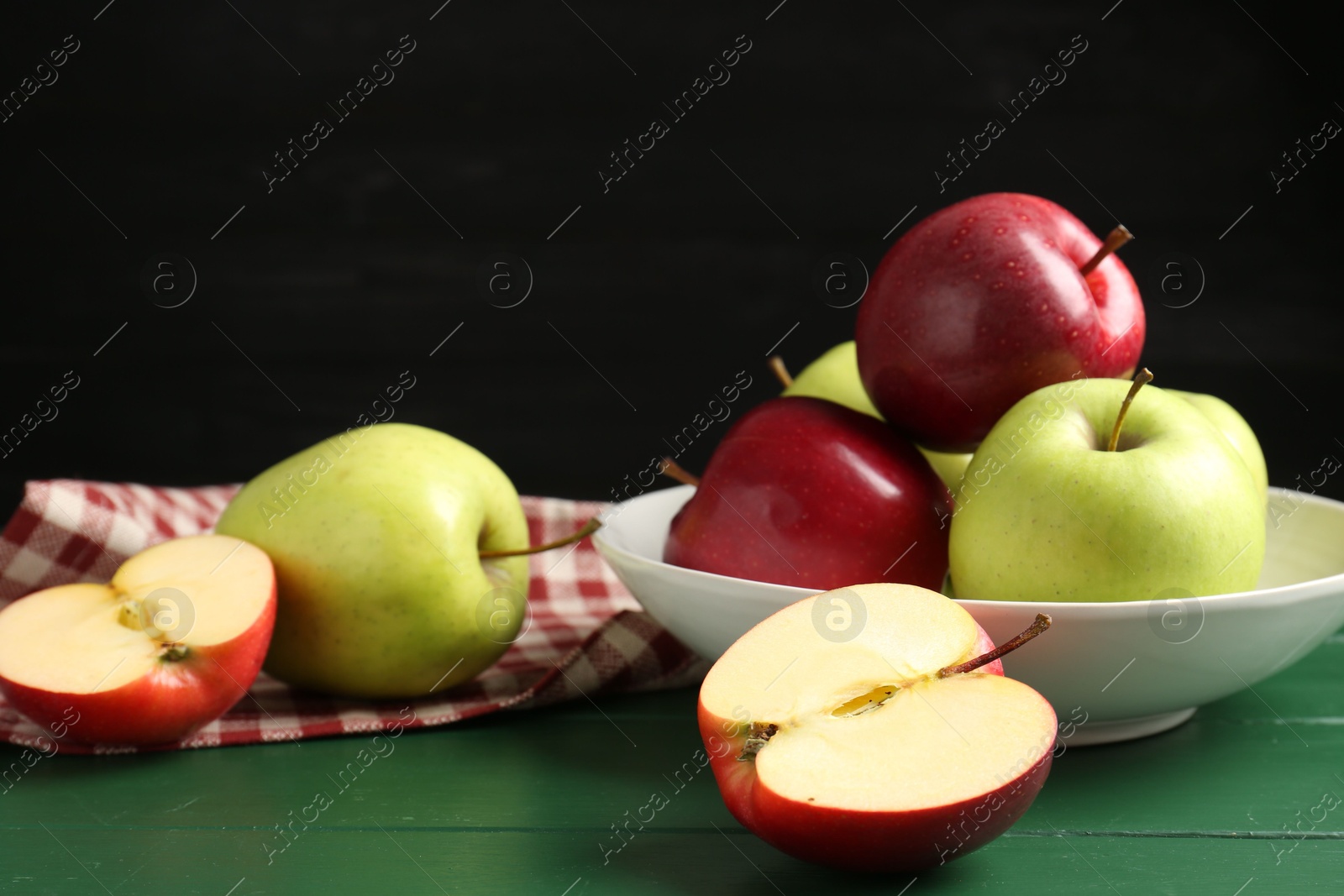 Photo of Fresh ripe apples on green wooden table