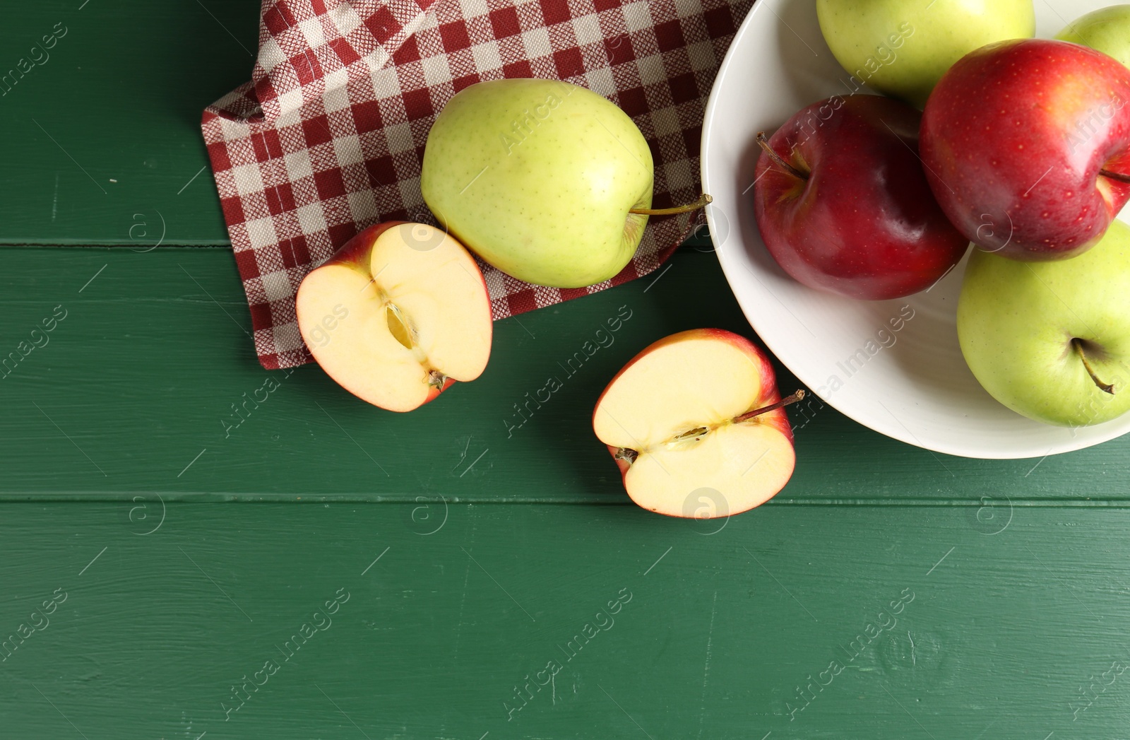 Photo of Fresh ripe apples on green wooden table, flat lay