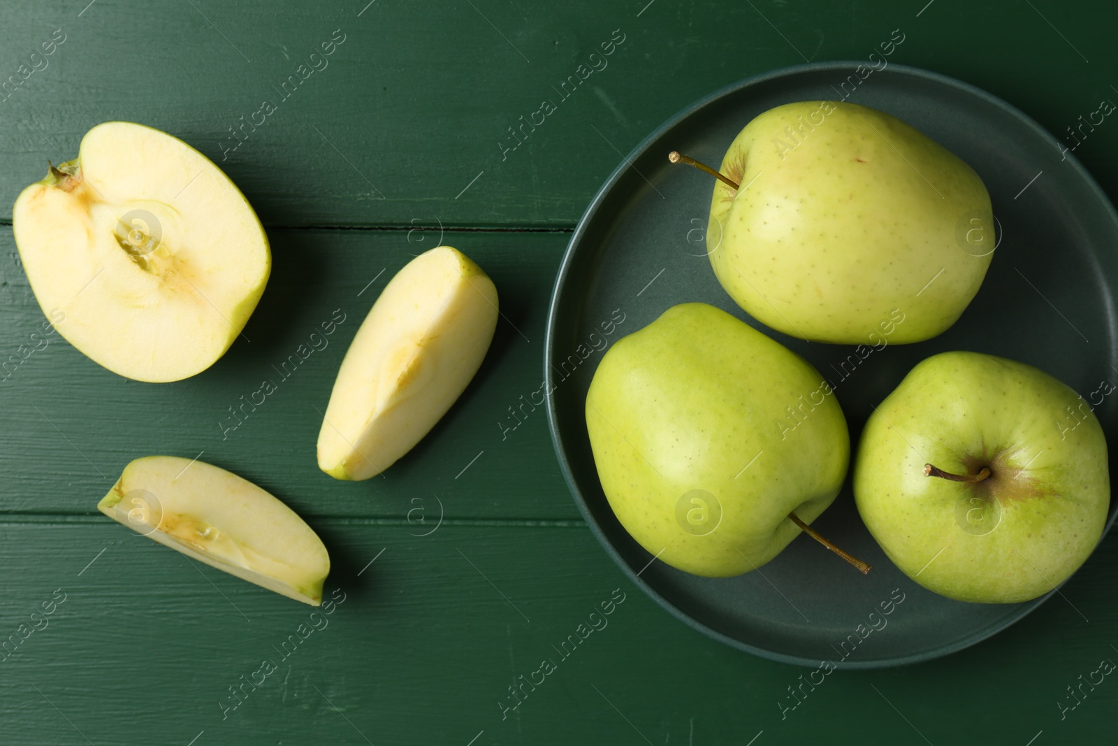 Photo of Fresh ripe apples on green wooden table, flat lay