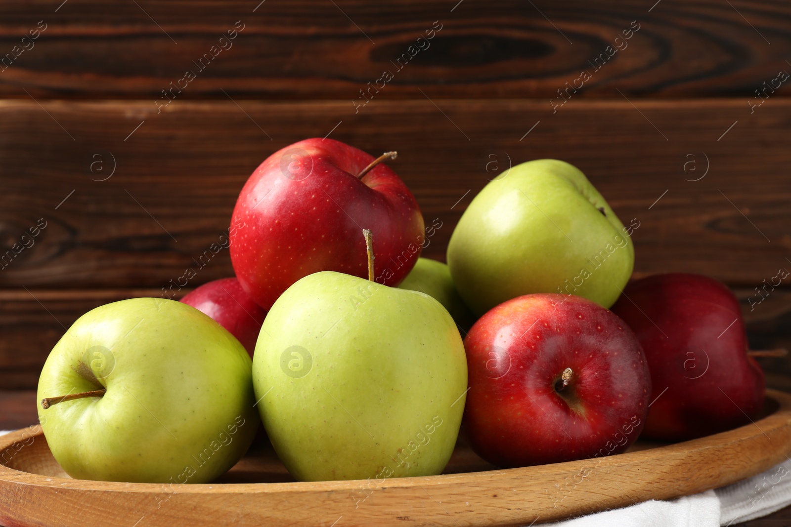 Photo of Fresh red and green apples on wooden table, closeup