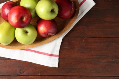 Photo of Fresh red and green apples on wooden table, top view. Space for text