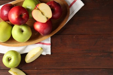 Photo of Fresh red and green apples on wooden table, flat lay. Space for text